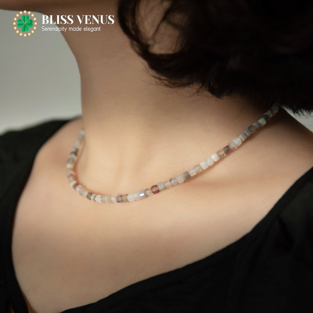 Close-up of Persian Gulf agate beaded necklace showing creamy white and brown natural stone texture