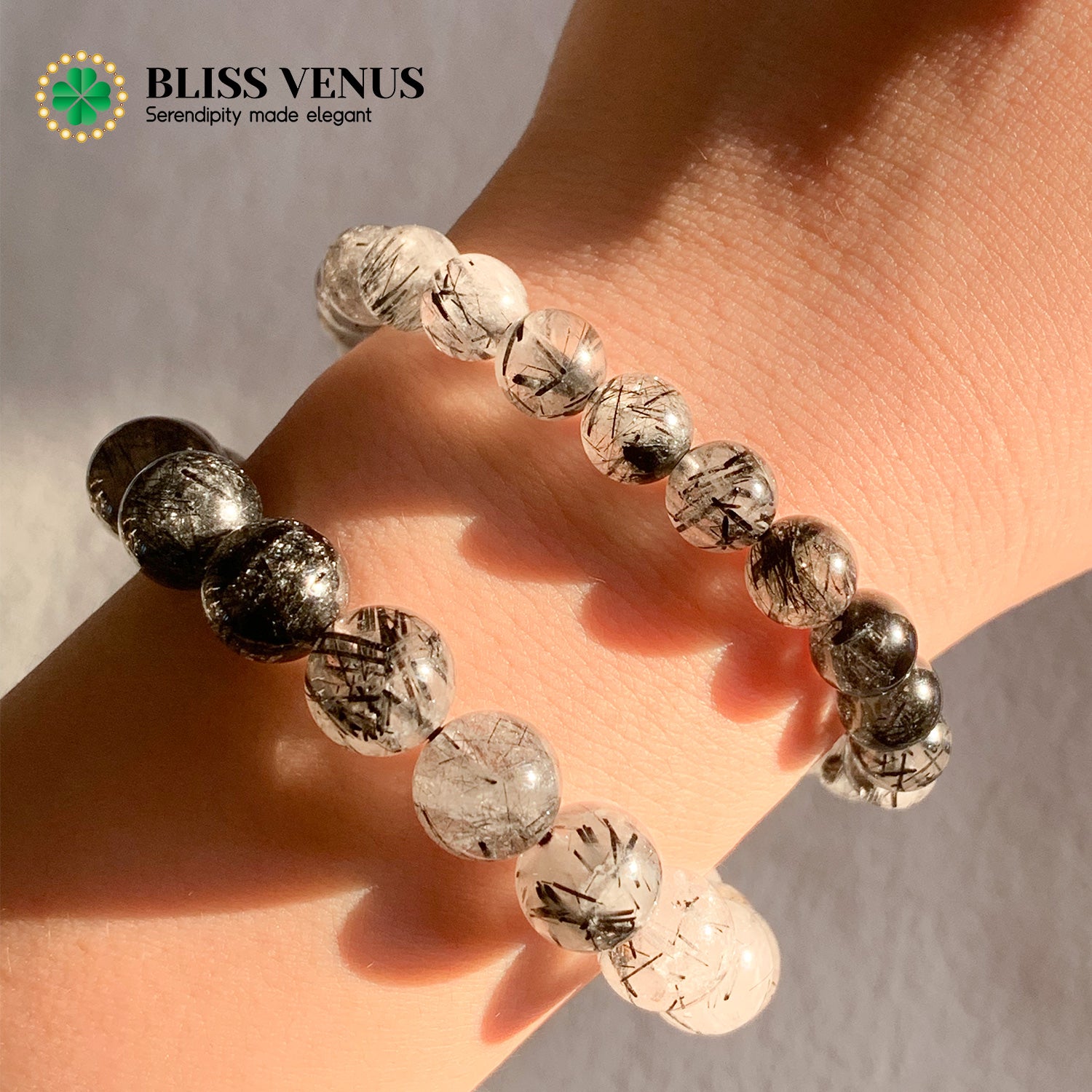 Close-up of black hair crystal bracelet showing unique black tourmaline inclusions and clear quartz