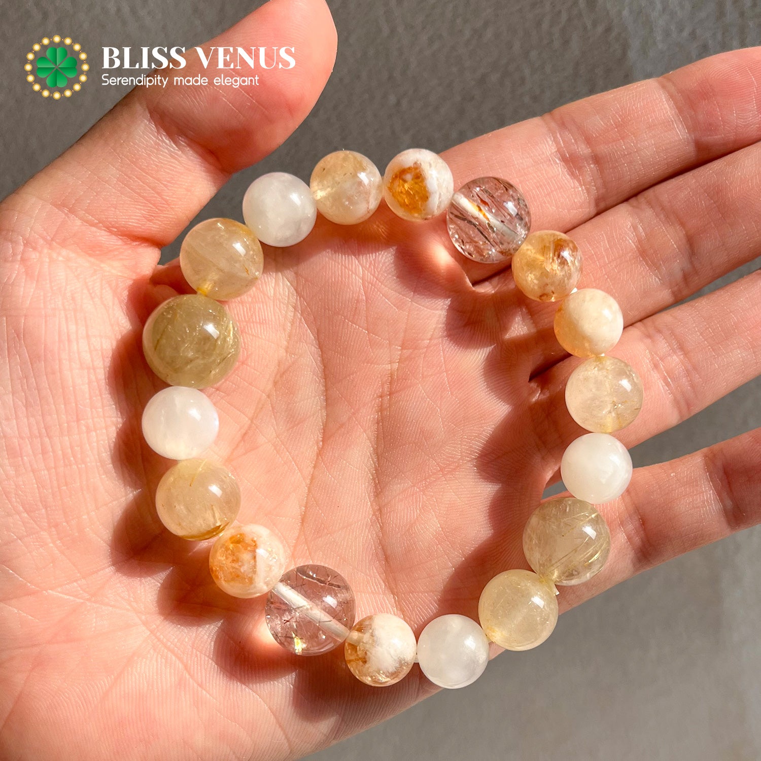 Close-up of golden hair crystal moonstone yellow fluorite and super 7 bracelet showing natural earth colors
