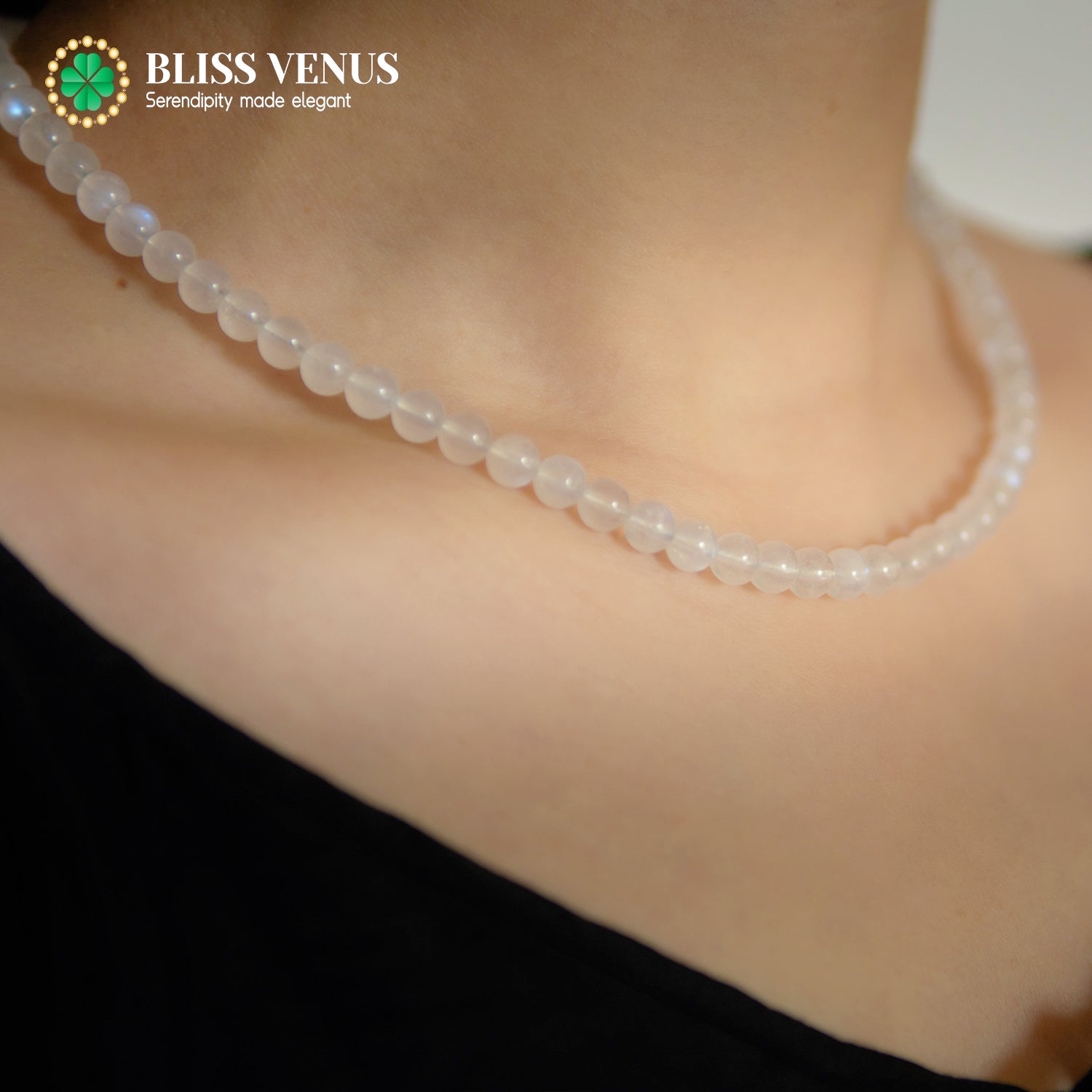 Close-up of moonstone beaded necklace showing natural white gemstone luster and iridescence