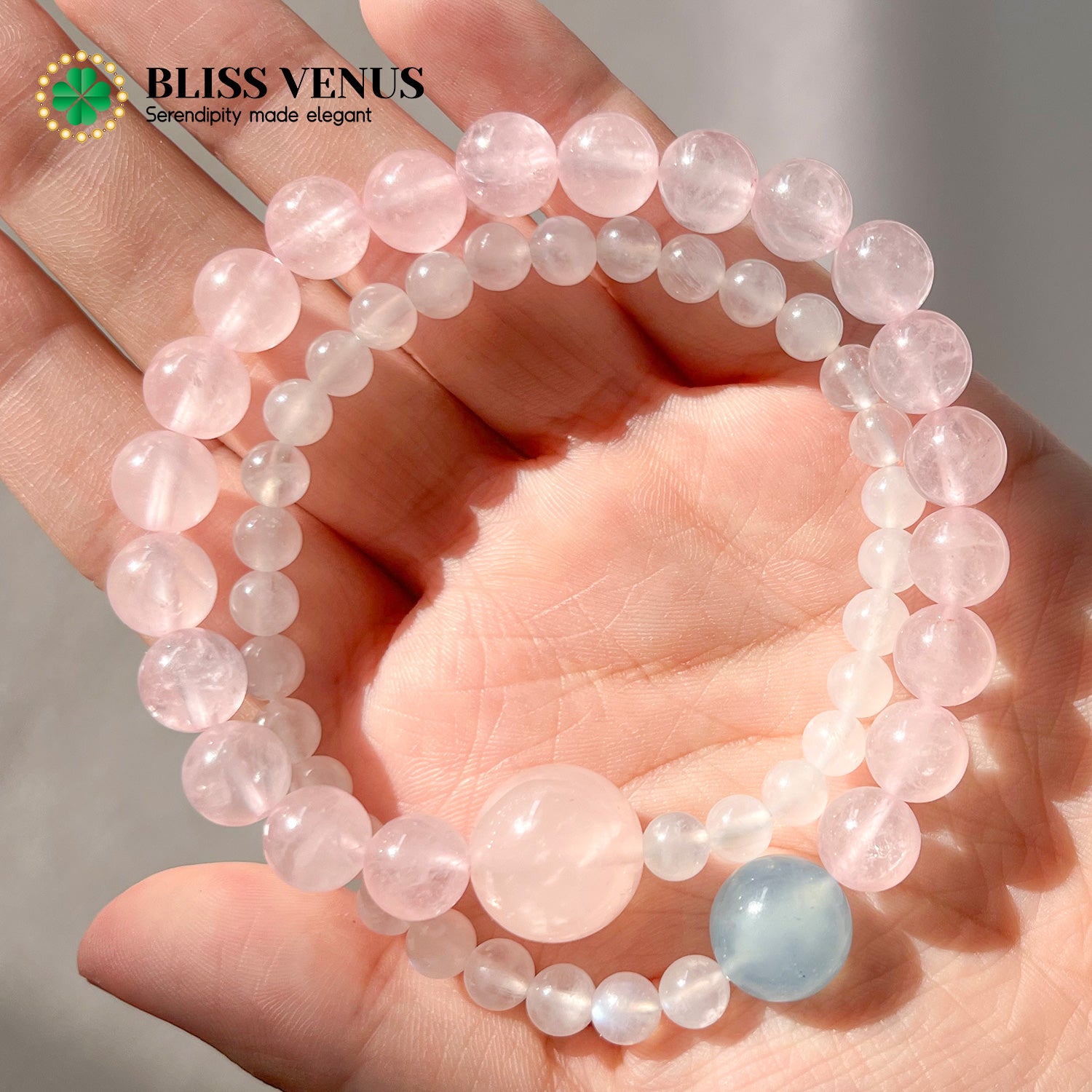 Close-up of pink crystal moonstone aquamarine double layer bracelet showing natural white pink and blue gemstones