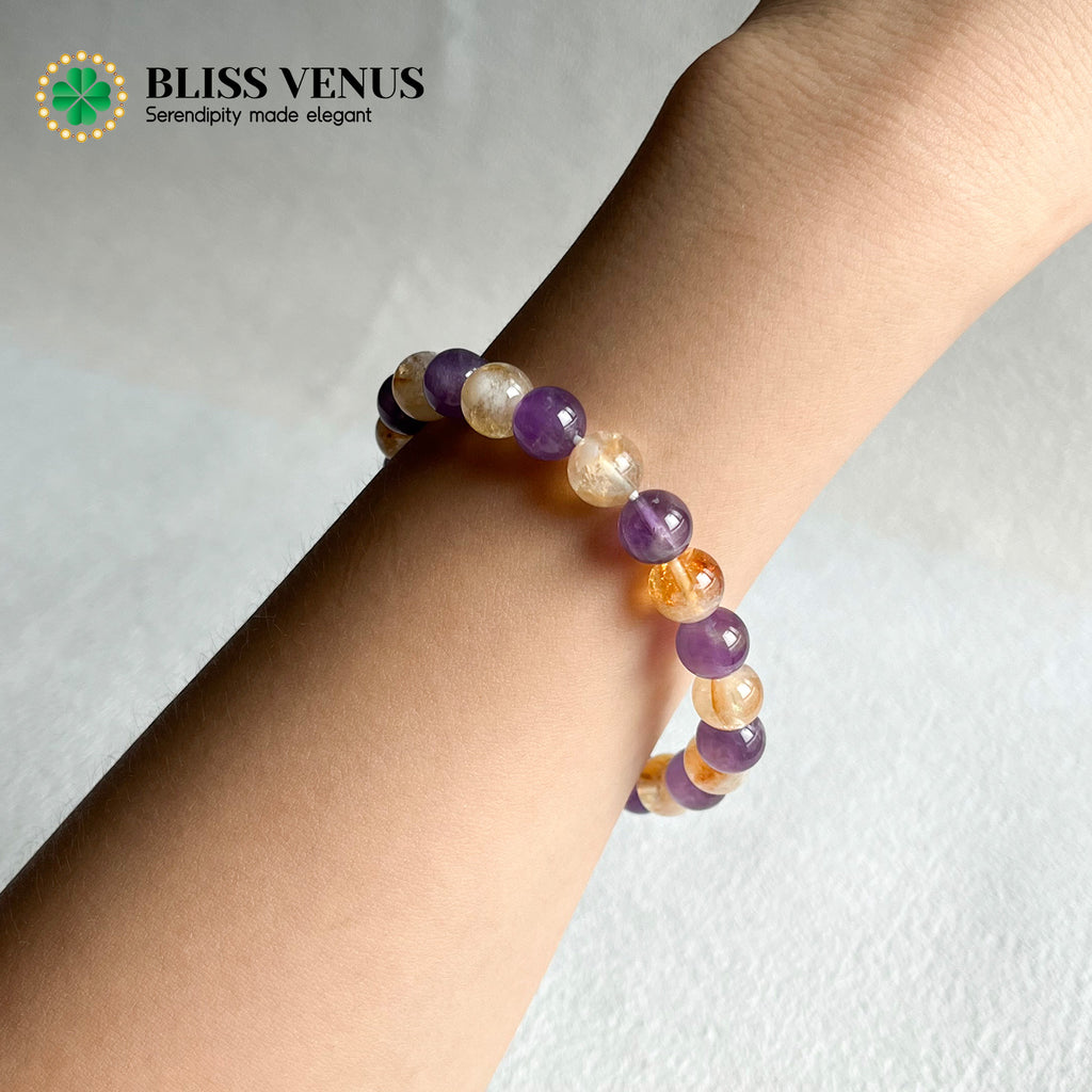 Close-up of purple and yellow crystal bracelet showing natural amethyst and citrine gemstone colors