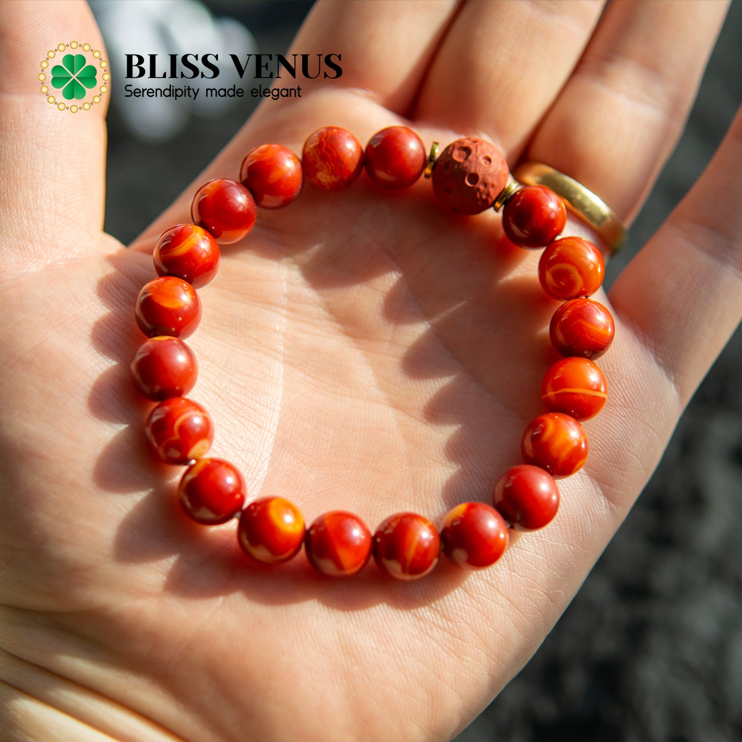 Close-up of red agate bracelet showing natural stone texture and vibrant red color