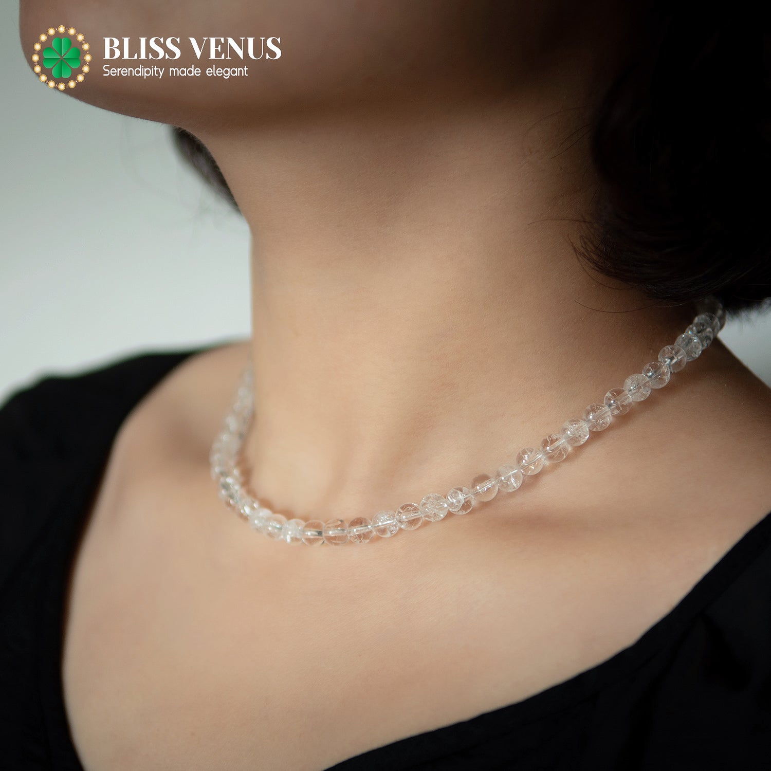 Close-up of white crystal beaded necklace showing transparent gemstone clarity and natural luster