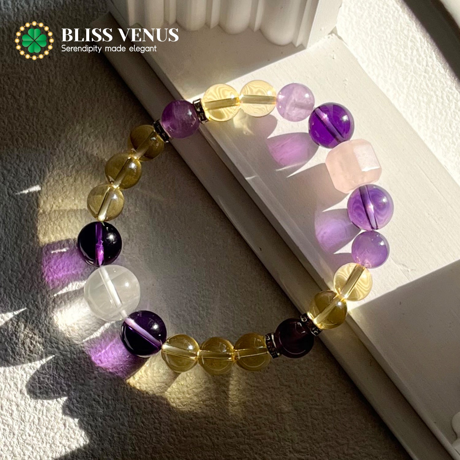Close-up of yellow white purple pink crystal bracelet showing natural citrine, clear quartz, amethyst and rose quartz