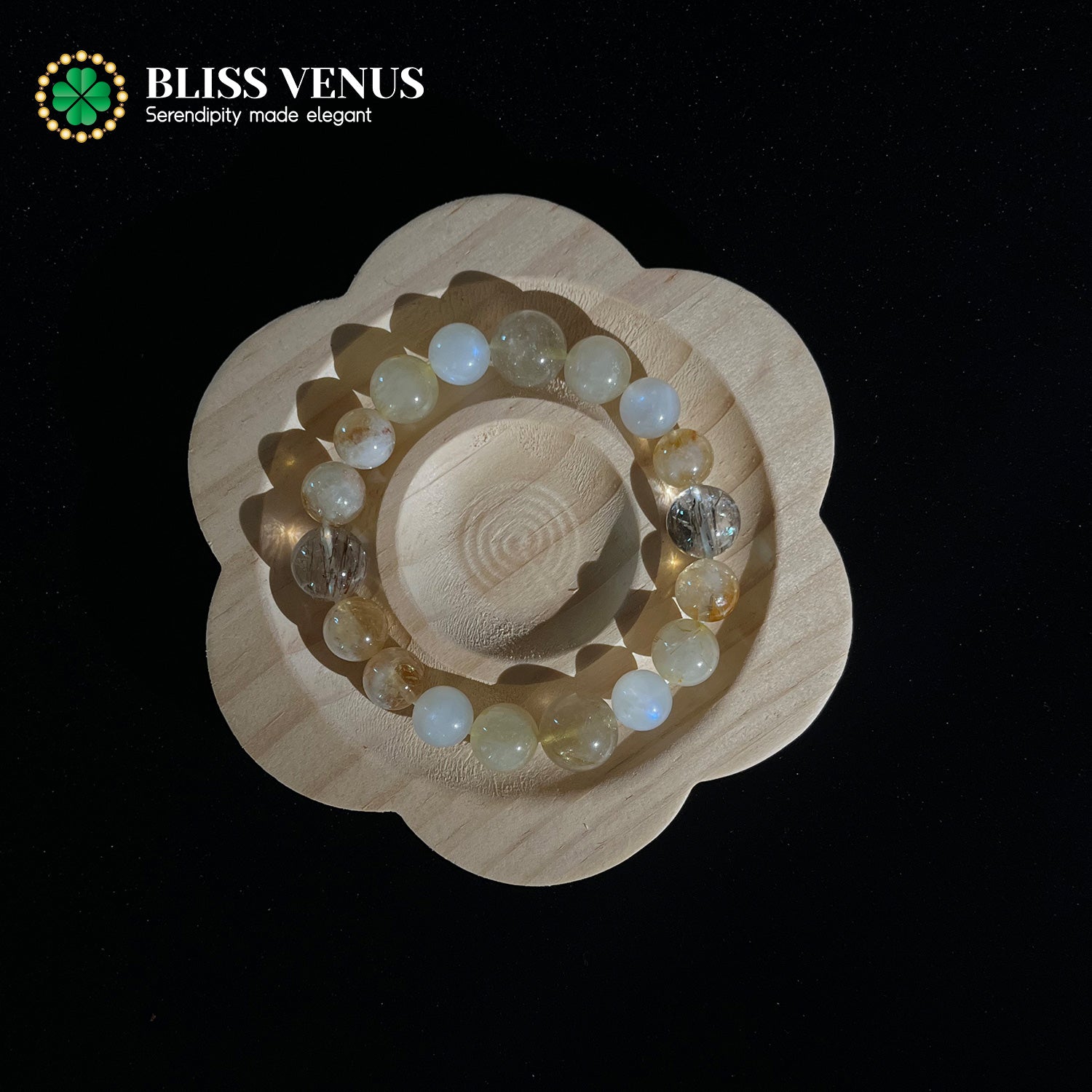 Multi-crystal bracelet detail view displaying golden rutile quartz, moonstone, fluorite tower and black golden super 7