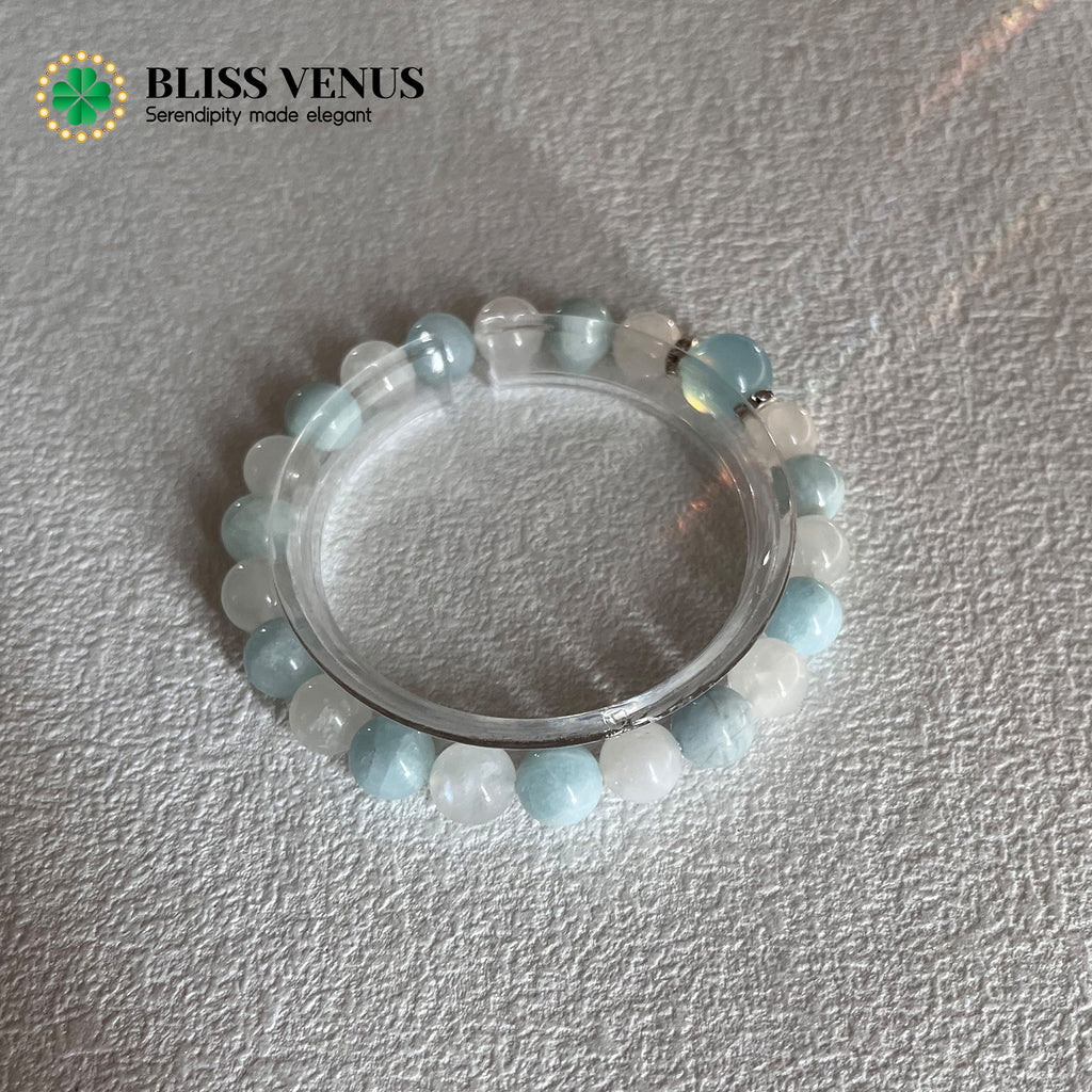 Natural aquamarine and moonstone beaded bracelet worn on wrist, March and June birthstones