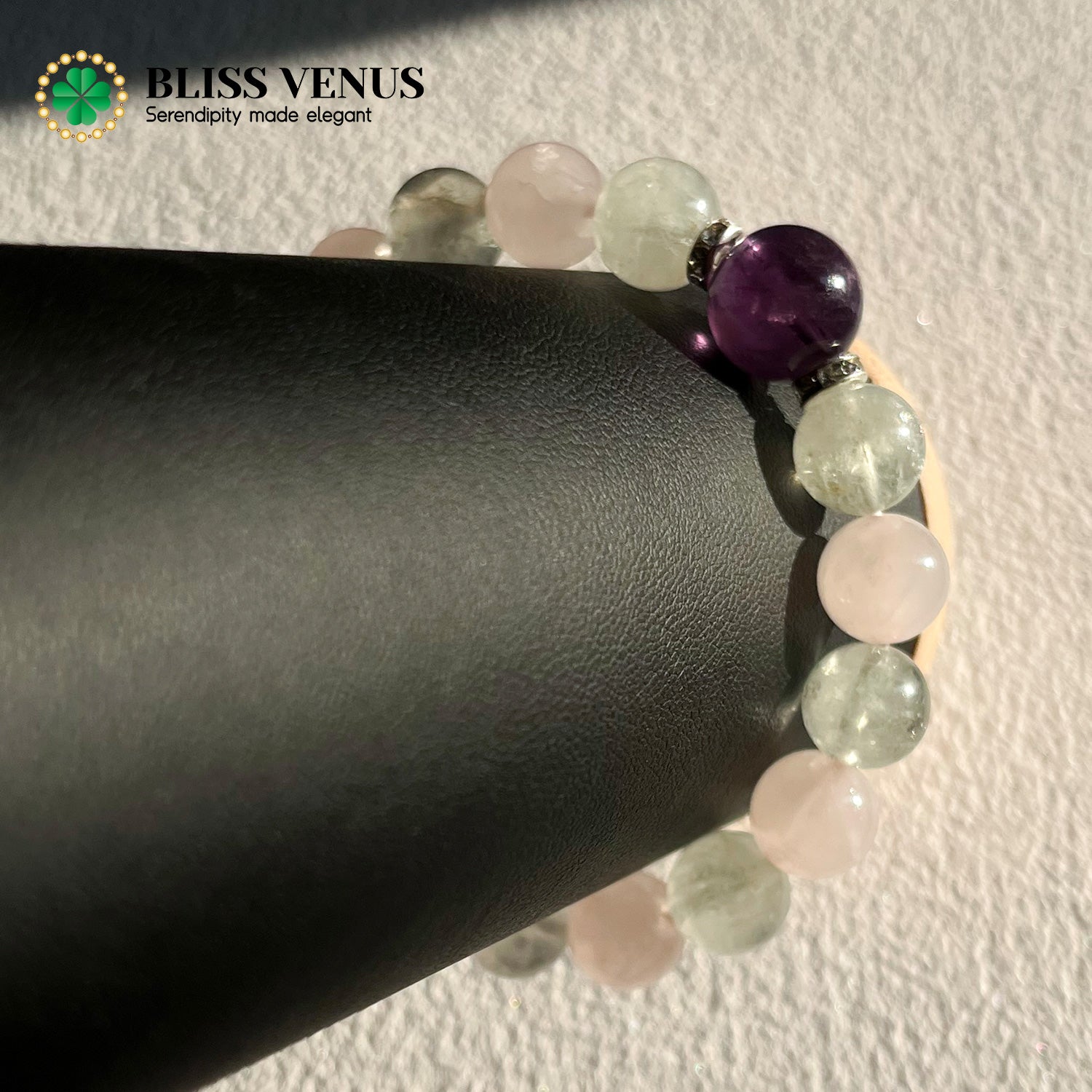 Natural pink green purple crystal beaded bracelet worn on wrist, heart chakra and crown chakra stones