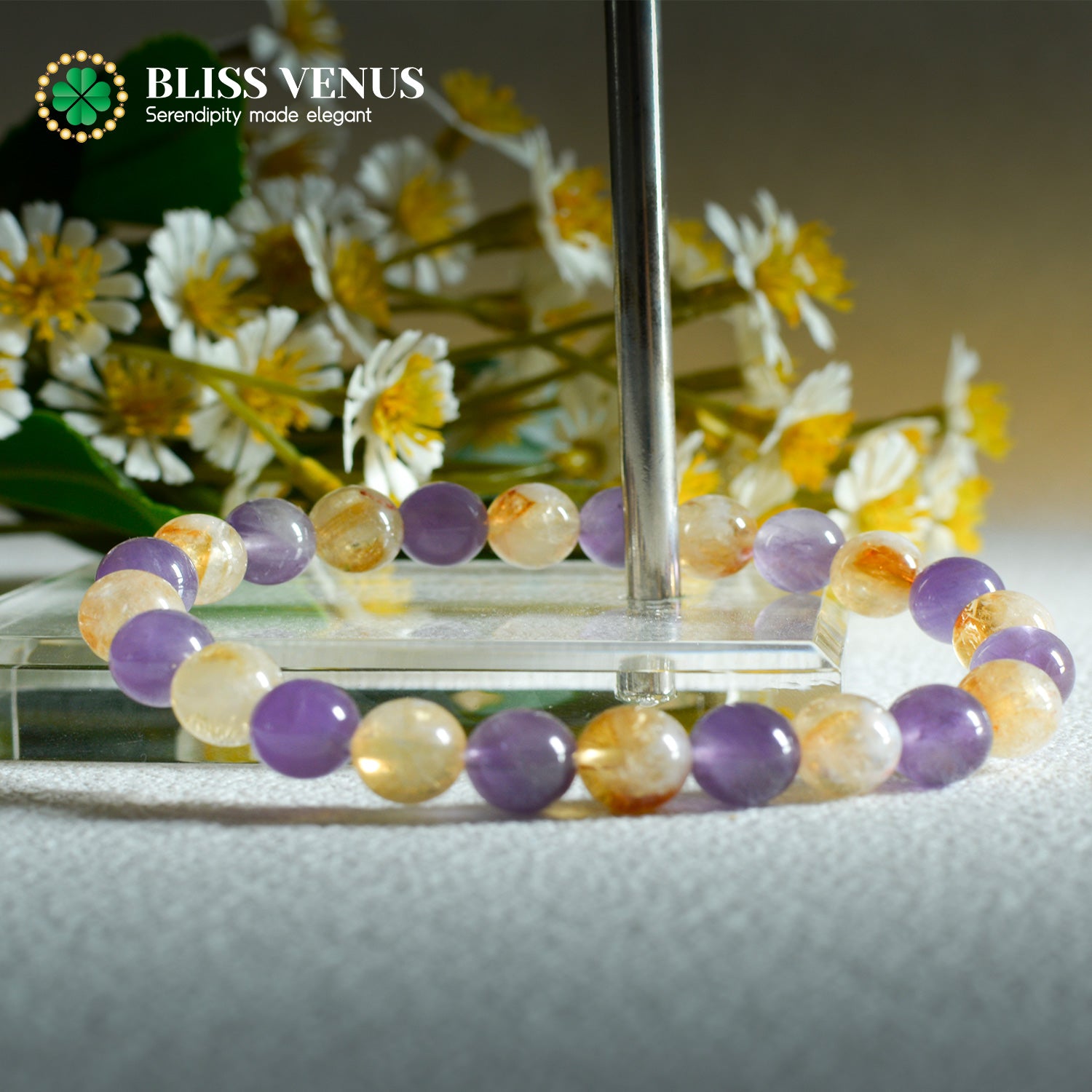 Natural purple and yellow crystal beaded bracelet worn on wrist, material and spiritual balance