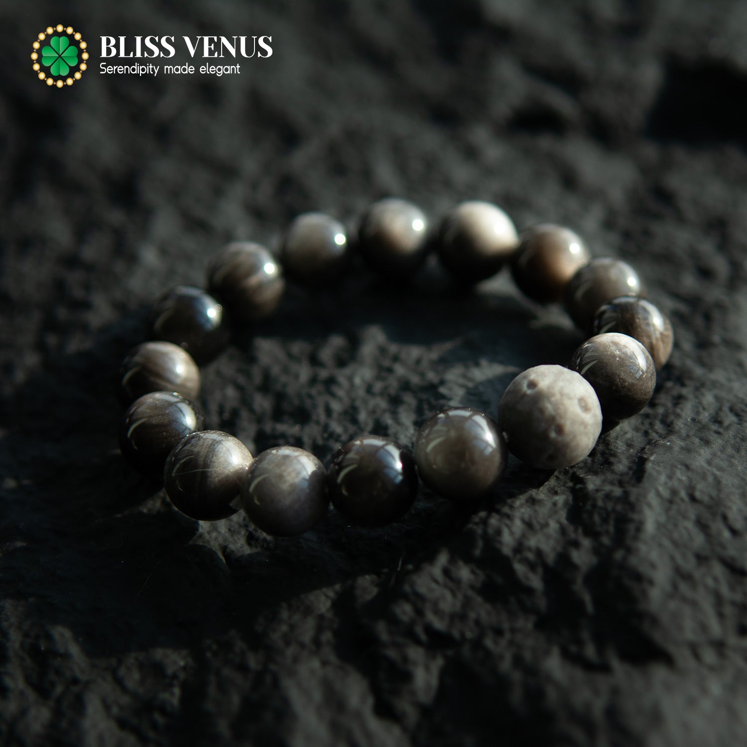 Obsidian protection bracelet detail view displaying bead size and moon-inspired design