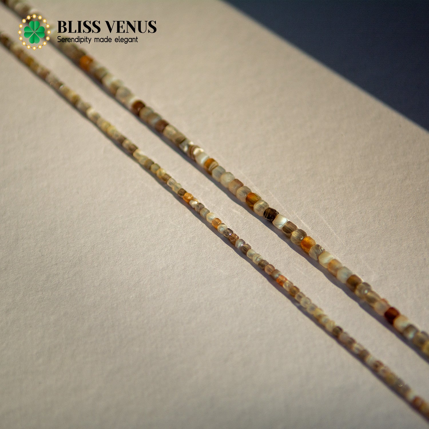 Side angle of lucky star agate necklace displaying bead size variation and gold clasp detail