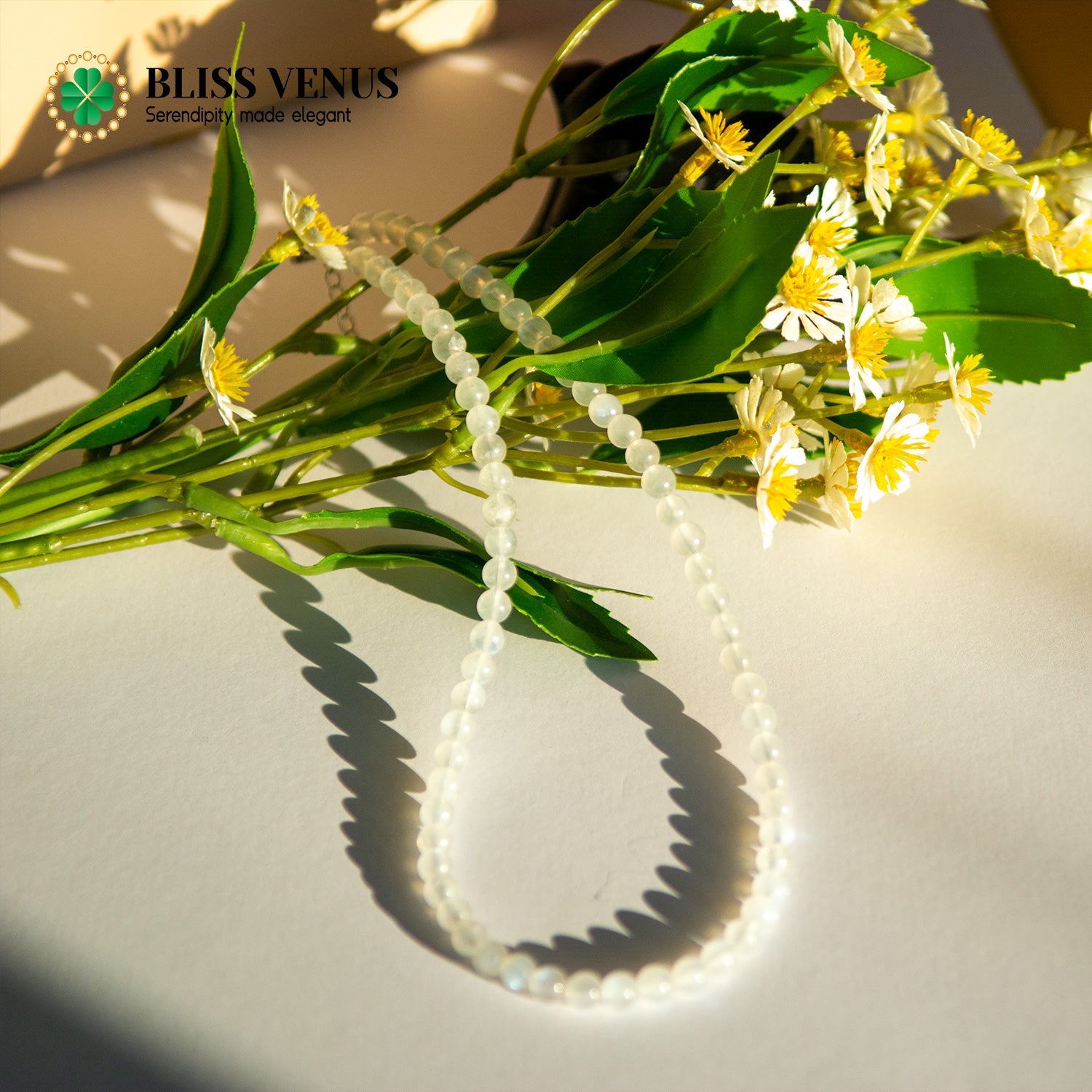 Side angle of moonstone lover's stone necklace displaying bead size and gold clasp detail