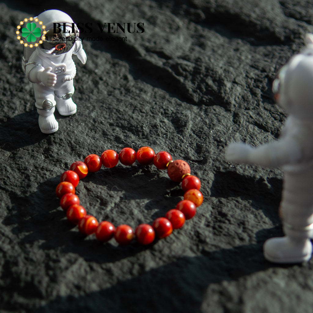 Side angle of red agate bracelet showing bead arrangement and natural gemstone luster