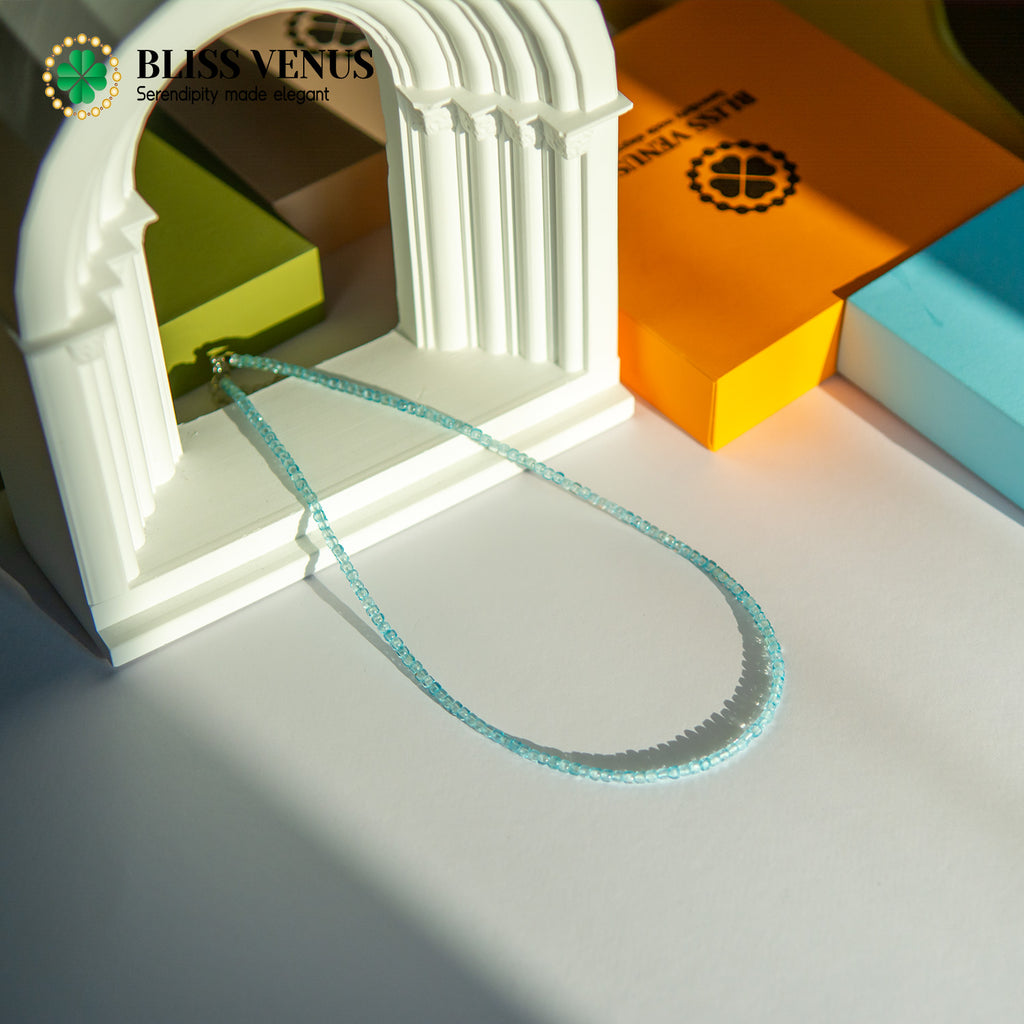 Side angle of tourmaline friendship necklace displaying bead arrangement and gold clasp