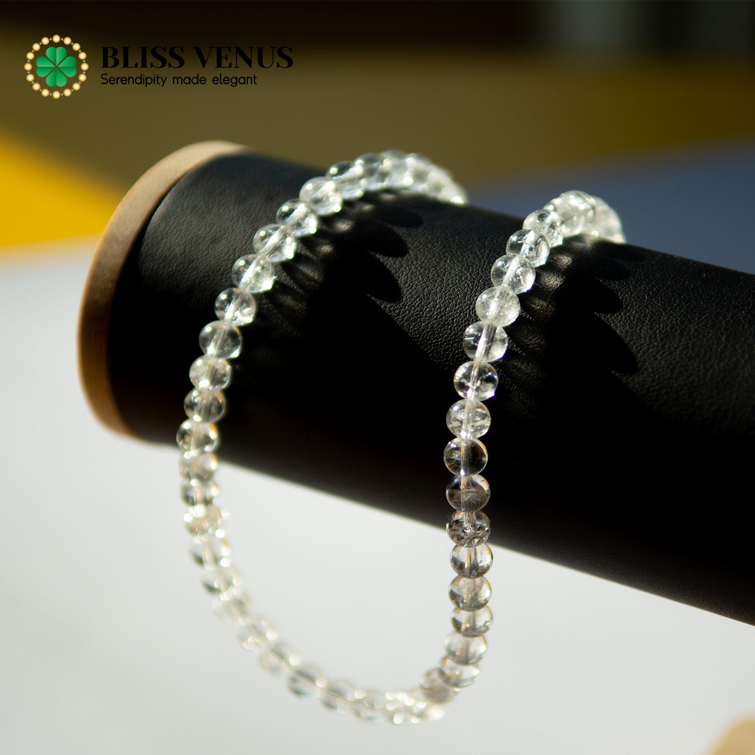 Side angle of white crystal energy stone necklace displaying bead size and gold clasp detail