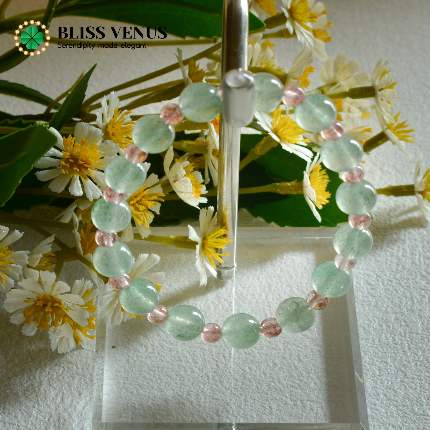 Side view of red green strawberry crystal bracelet displaying bead arrangement and natural patterns